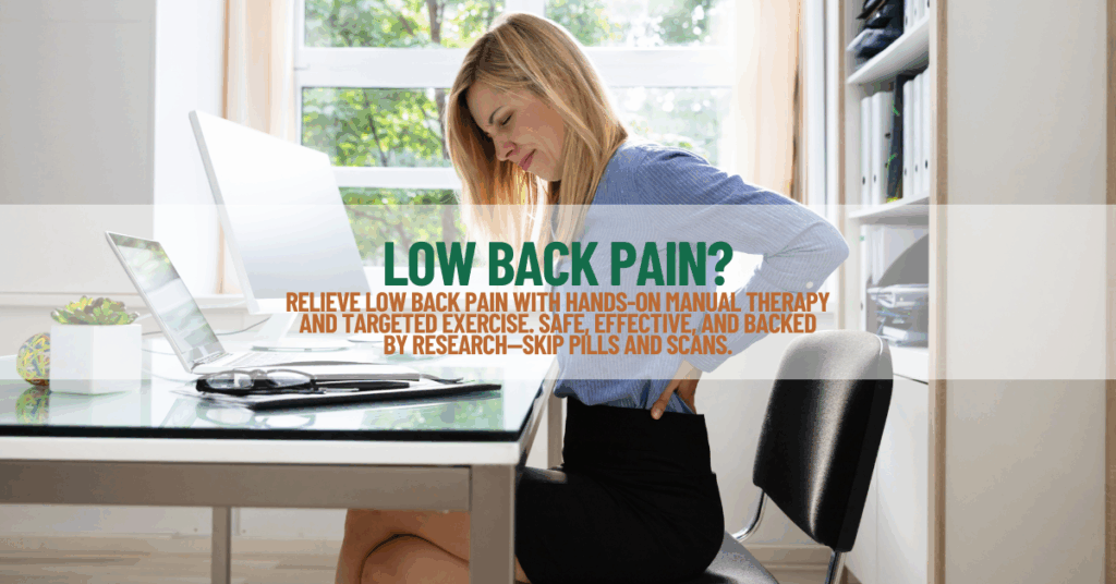Woman experiencing low back pain while sitting at her work desk, highlighting the need for manual therapy and exercise for relief.