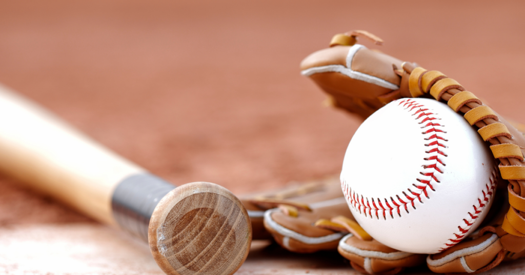 Baseball glove, ball, and mat to showcase Mishock PT's expert guide on the relationship between baseball, velocity, spin rate, and injury risk to help prevent training injury.